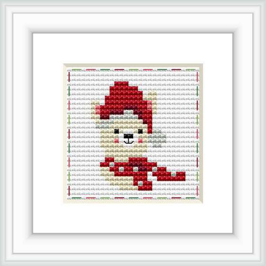 The image presents a cross stitch pattern of a stylized red, white, gray, brown, and black llama centered on a piece of fabric, framed within a white picture frame.