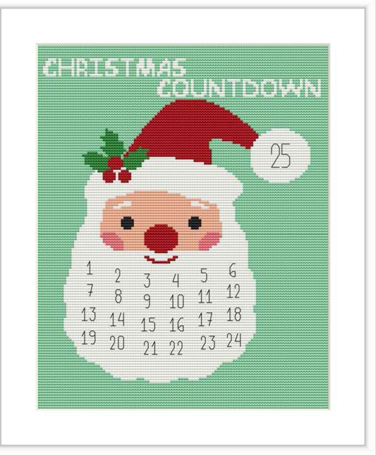 The image shows a cross-stitch pattern featuring Santa Claus's face, with a countdown calendar on his beard, numbered from 1 to 24, and the number 25 on his hat, symbolizing Christmas day.