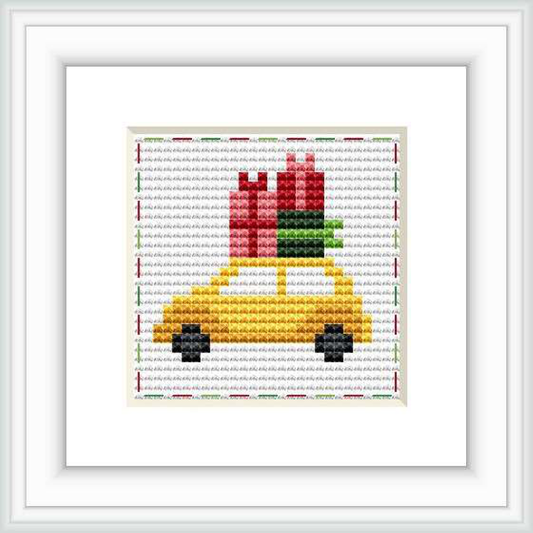 This image features a cross stitch pattern of a yellow car piled with red and green presents. The car is depicted in a pixel art style on a gridded background.