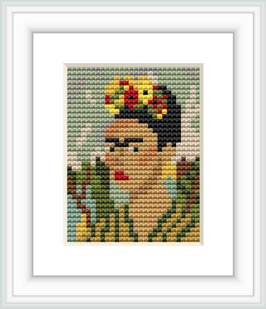 This cross stitch pattern depicts a pixelated portrait of Frida Kahlo with a floral adornment in her hair, against a background with shades of green.