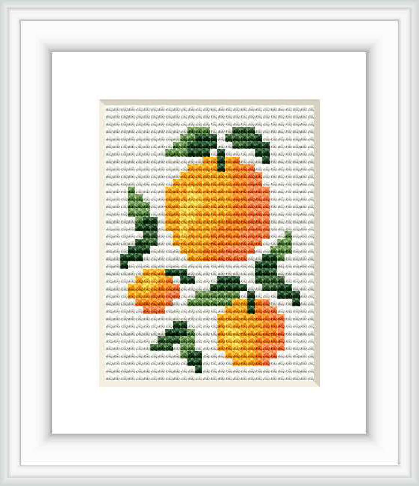 An embroidered cross stitch pattern of mini oranges with green leaves, framed in white and displayed against a grey grid backdrop.