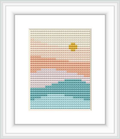 The image depicts a cross stitch pattern featuring a gradient of colors that resemble a sunrise over a landscape, starting with green at the bottom, ascending through shades of pink and orange, and topped with a small yellow dot as the sun.