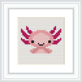 The image displays a square cross stitch pattern featuring a stylized axolotl in a simplistic, cartoonish form. The pattern is predominantly pink with accents in magenta, white, and black, framed within a classic frame, against a white background.
