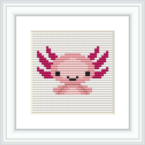 The image displays a square cross stitch pattern featuring a stylized axolotl in a simplistic, cartoonish form. The pattern is predominantly pink with accents in magenta, white, and black, framed within a classic frame, against a white background.