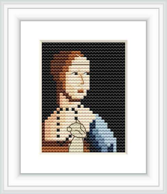 The image features a framed cross stitch pattern that replicates 'The Lady with an Ermine' by Leonardo da Vinci. There's a background that fades from black on the upper part to dark blue at the bottom, providing contrast for the stitched portrait in the center, which is a simplified, pixelated depiction of the subject, framed in white.