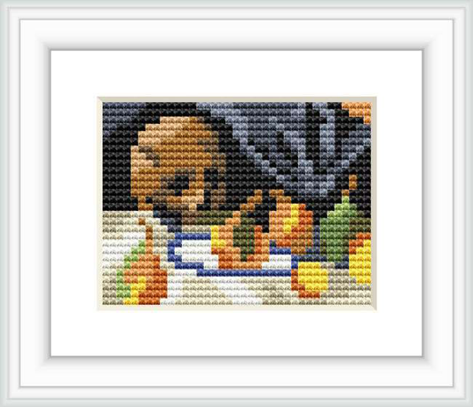 This cross stitch design replicates a still life painting featuring a skull centered in the foreground, a bottle to its right, and assorted fruits in the foreground. It's laid upon a surface with a dark background and draped cloth across the composition.