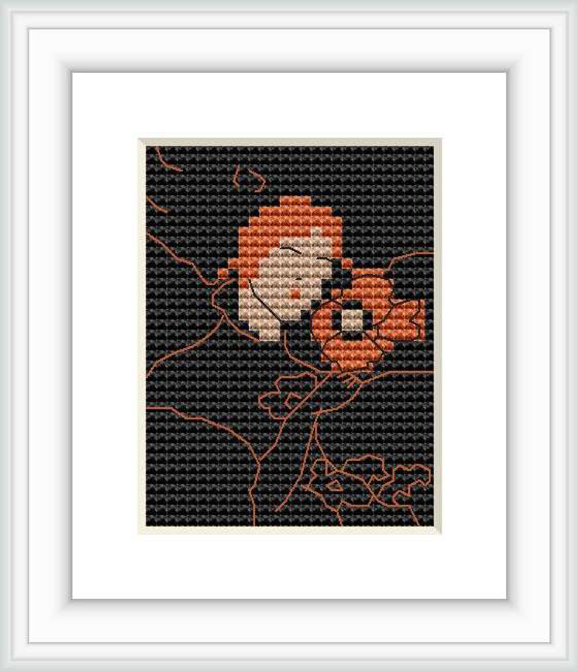 The image depicts a close-up cross stitch pattern of a flowering plant with petals in beige and orange, and leaves in shades of brown and crimson, on a black background.