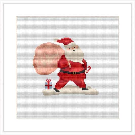 The image showcases a cross stitch pattern of Santa Claus carrying a large pink bag over his shoulder, presumably filled with gifts, and a wrapped present at his feet. The design is on a white background.