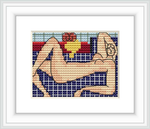 A cross stitch rendering of a reclining nude figure, with sections of different colors and patterns, framed and matted on a wall.
