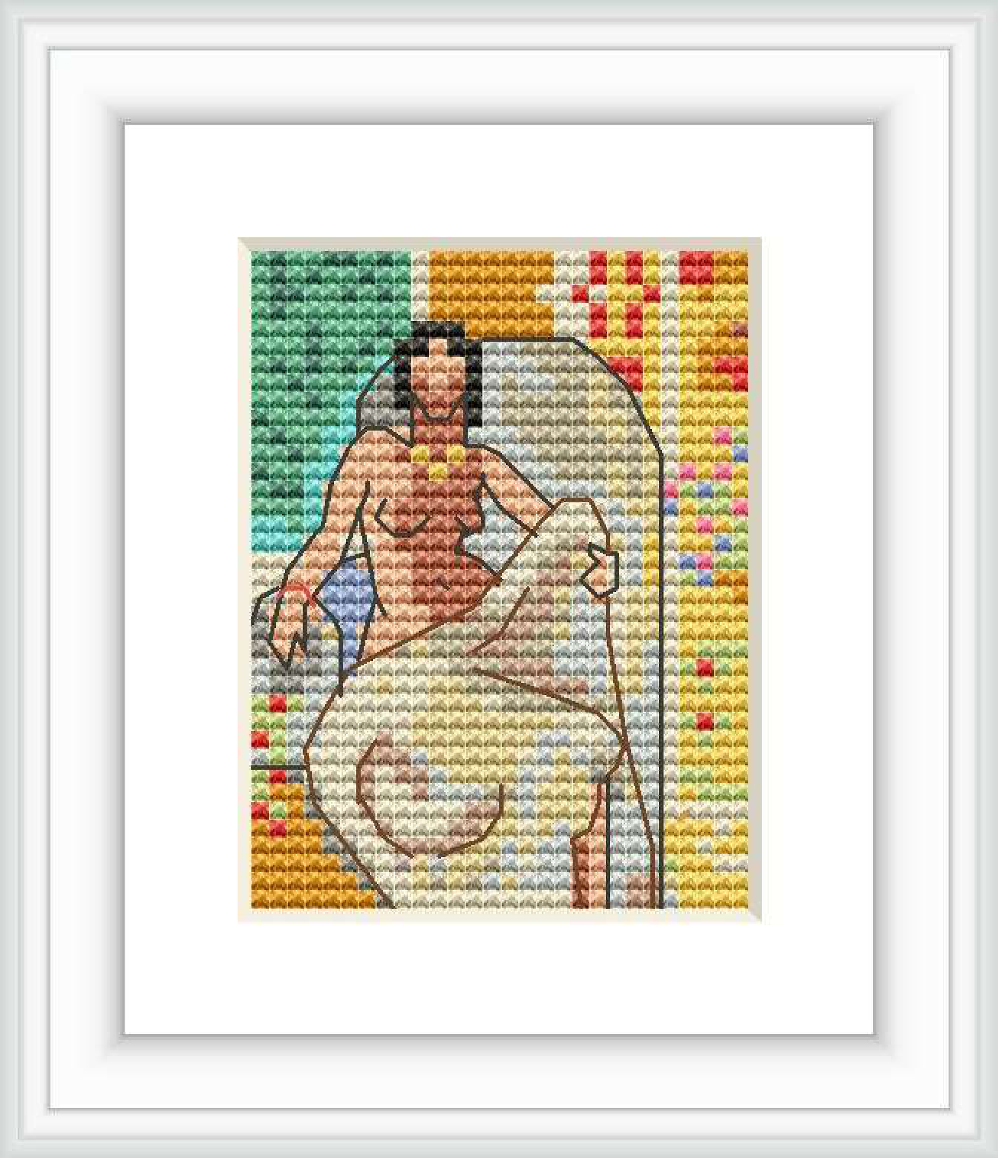 The image shows a cross stitch pattern of a stylized reclining woman against a multicolored background, framed and displayed on a white surface.