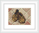 The image depicts a finished cross stitch pattern framed in white. It features a pair of yellow and brown toned shoes resembling the style of Vincent Van Gogh's painting. The shoes are placed against a background with subtle geometric patterns.