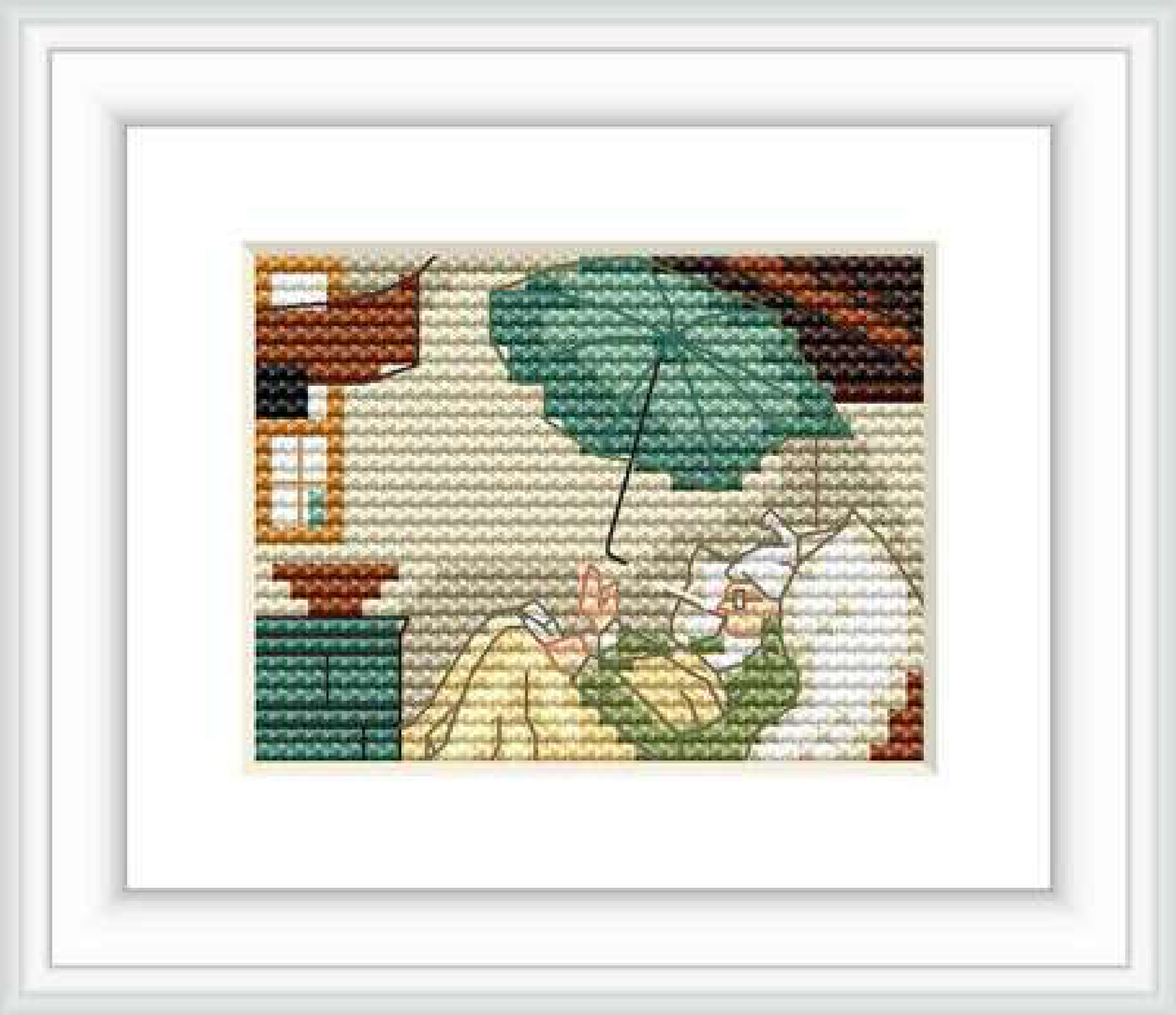 The image shows a cross-stitch pattern representing an indoor scene with a male figure lying on a bed draped in a green blanket, reading beneath an umbrella which seems to be protecting him from a leaky roof. The garret room has a warm palette, with wooden beams and a window.