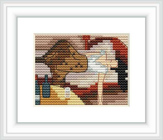 The cross stitch pattern features a profile of a figure facing left with visible facial features and upper body, set against a mottled background with varied colors. The scene is bordered by a simplistic frame, emphasizing the craftsmanship of the stitched design.