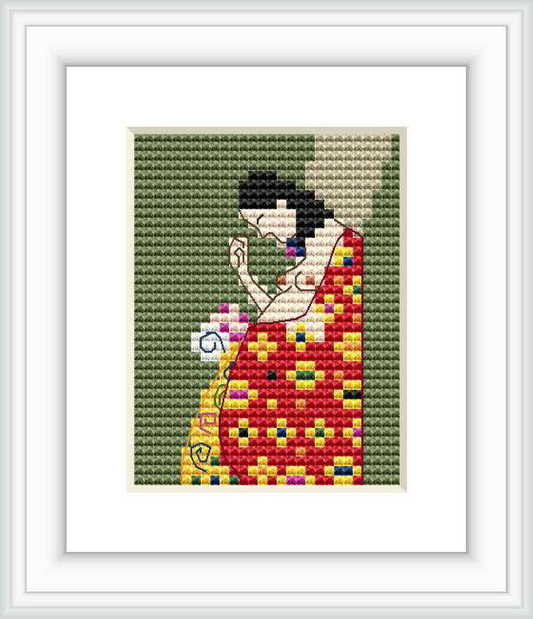 A framed cross stitch pattern showing a seated figure engaged in stitching, set against a patterned background. The figure is wearing a dress with Klimt's distinct mosaic style, and the foreground and background exhibit contrasting color themes.
