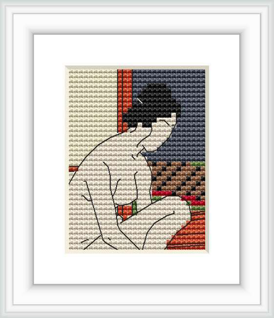 The image features a cross stitch recreation of 'Yokugo No Onna' by Hashiguchi Goyō, showing a seated Japanese woman in profile view from the back, contemplating. The background includes a navy panel and part of a red-orange border of traditional design.