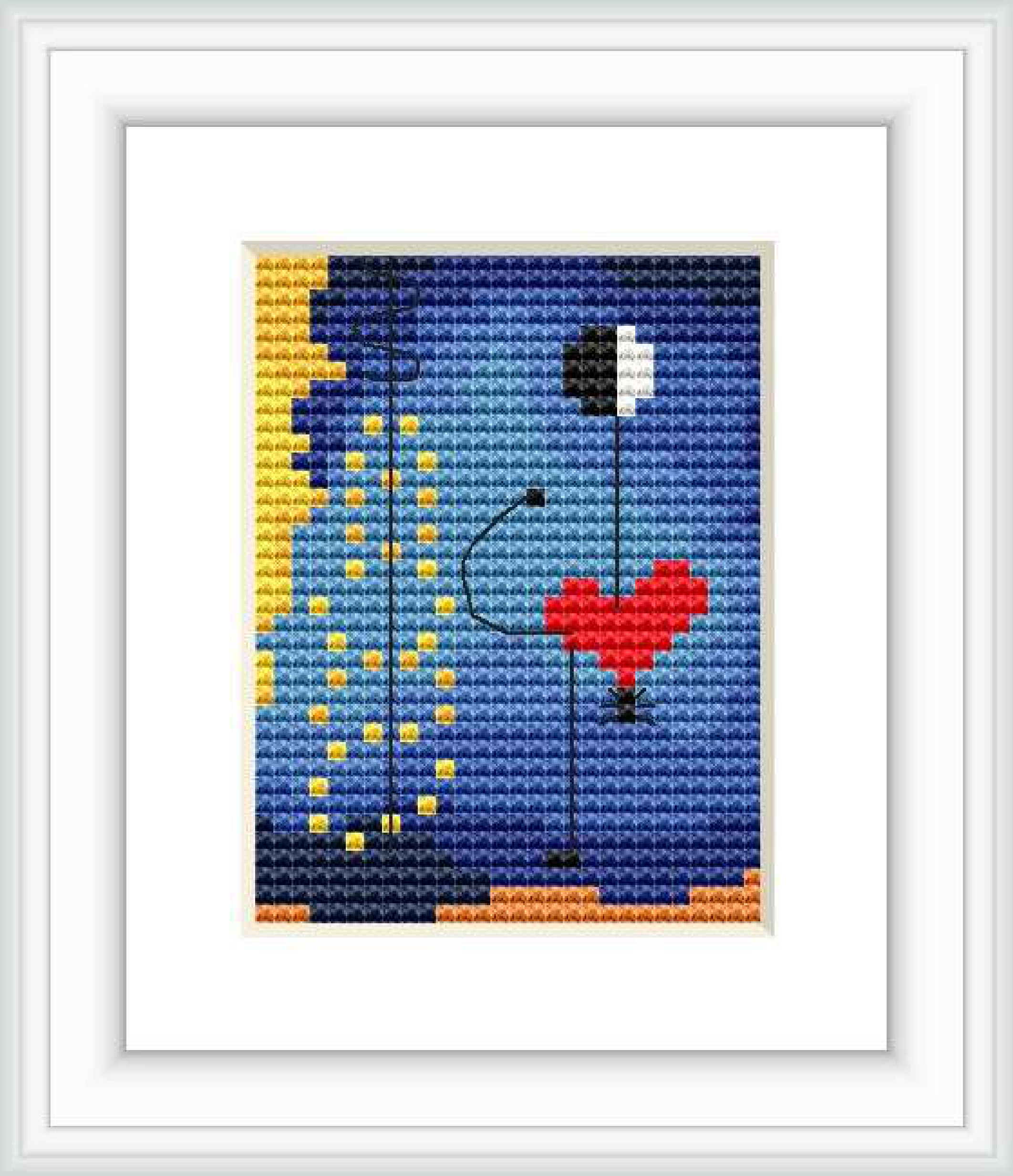 The cross stitch pattern features abstract shapes reminiscent of a dancer, with a large red heart in the center and dots arrayed in a yellow form to the left.