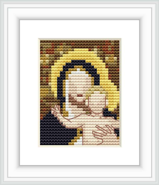 The cross stitch pattern depicts the bust of a serene Madonna with a halo, against a backdrop with lily motifs and a muted color palette.
