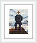 The cross stitch pattern shows a pixelated figure of a man standing on a promontory over a sea of fog, with his back facing the viewer. The landscape is composed of shades of blue, gray and touches of brown and white, representing a misty atmosphere.