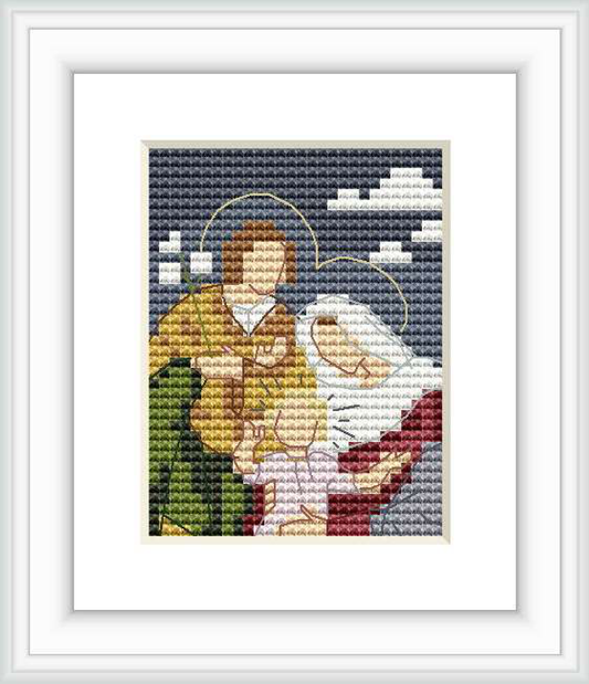 The image depicts a cross stitch pattern of the Holy Family with two figures, both with halos, surrounded by a dark blue background with white accents resembling clouds or a night sky.
