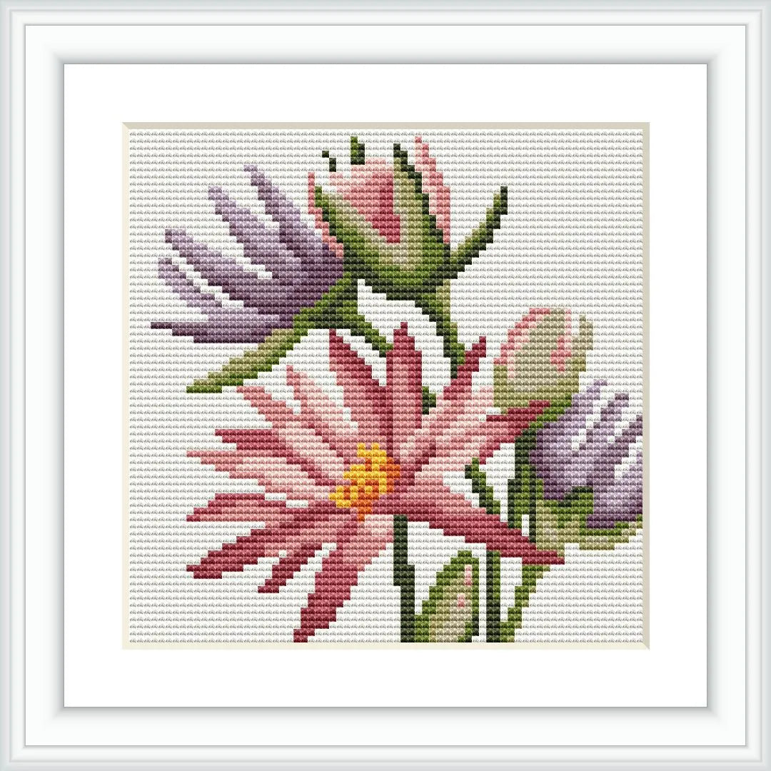 An image showcasing a framed cross stitch pattern featuring pink and purple flowers on a white background.