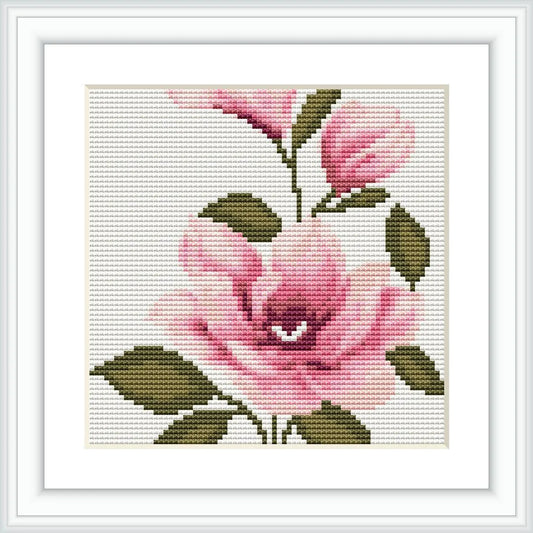 The image presents a framed cross stitch pattern depicting a single baby pink flower with green leaves on an off-white canvas, measuring 4.0 by 4.0 inches inside a frame.