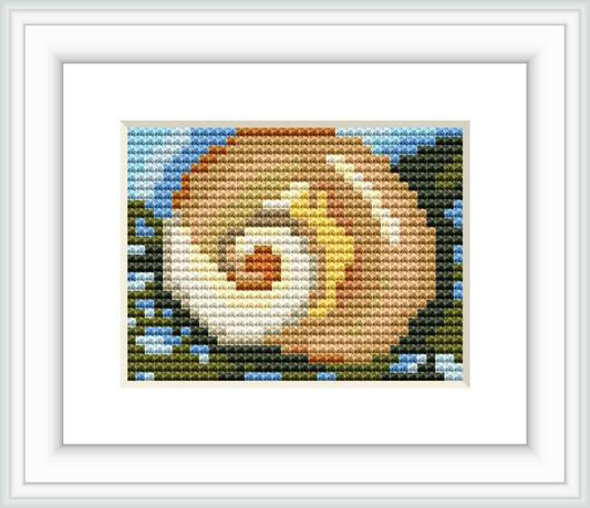 The image displays a detailed cross stitch pattern framed in white. It depicts a stylized marine shell surrounded by suggestions of seaweed, primarily in shades of pink and beige, against a blue and white background.