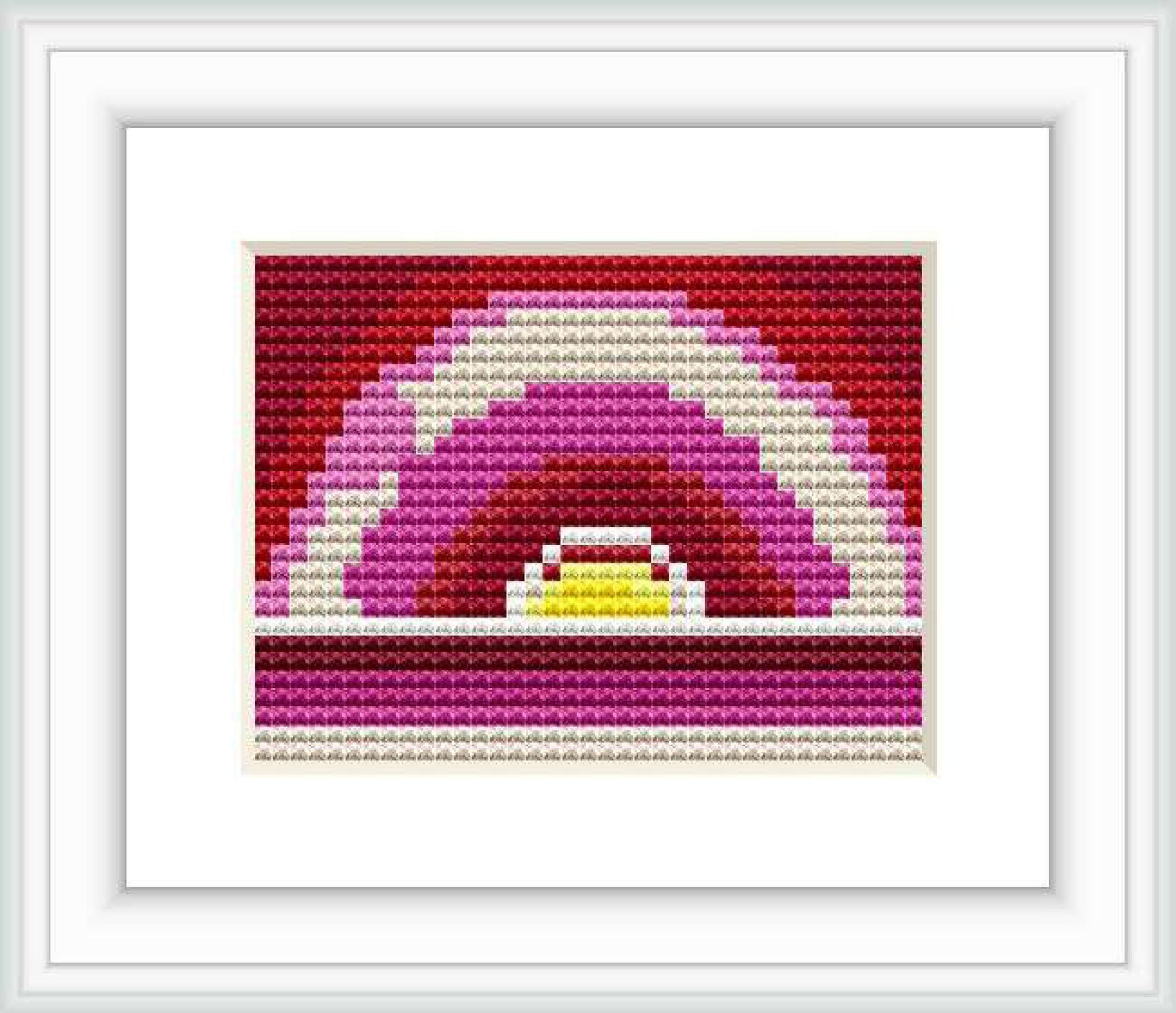 The image shows a framed cross stitch pattern that depicts an abstract sunrise with layered colors fading from dark purple to bright yellow at the center.
