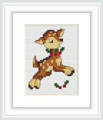 The image depicts a cross stitch pattern of a prancing deer, framed by a white border. The deer is rendered in shades of brown, with a red and green scarf and holly leaves.