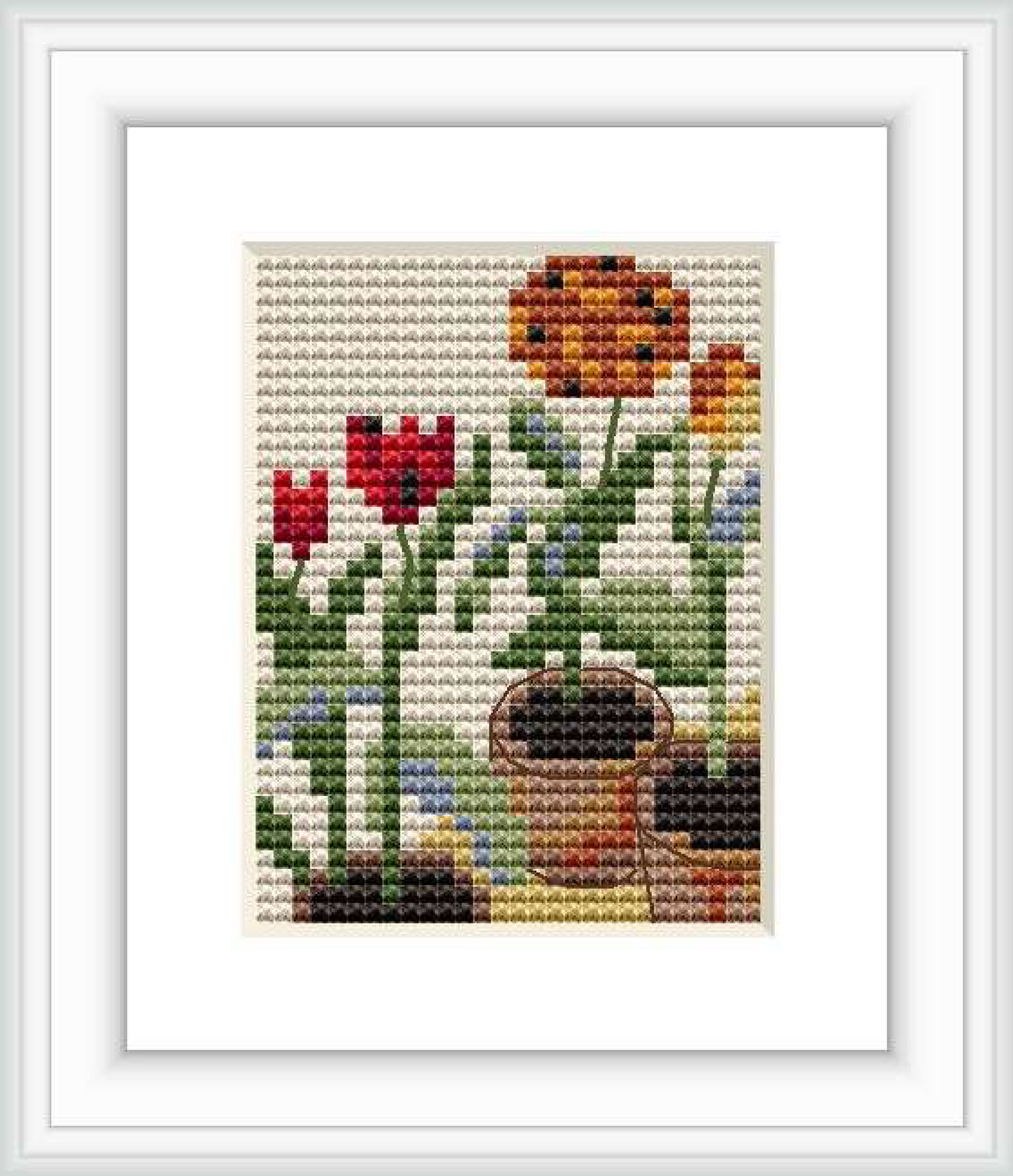 The image features a framed cross stitch design depicting three pots of tulips with varied colors such as red and yellow, set against a background with shades of blue and green.