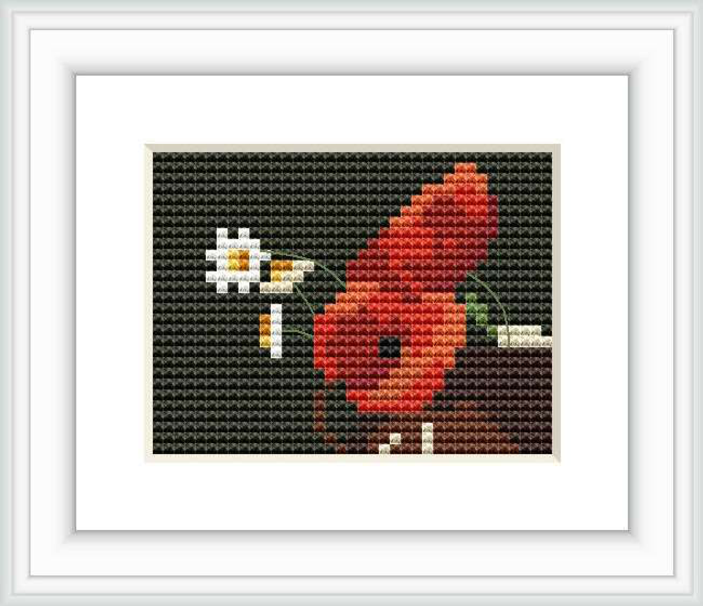 The cross stitch pattern features a large poppy flower on the left and a smaller daisy on the right against a dark background, suggestive of the painting style of Odilon Redon.