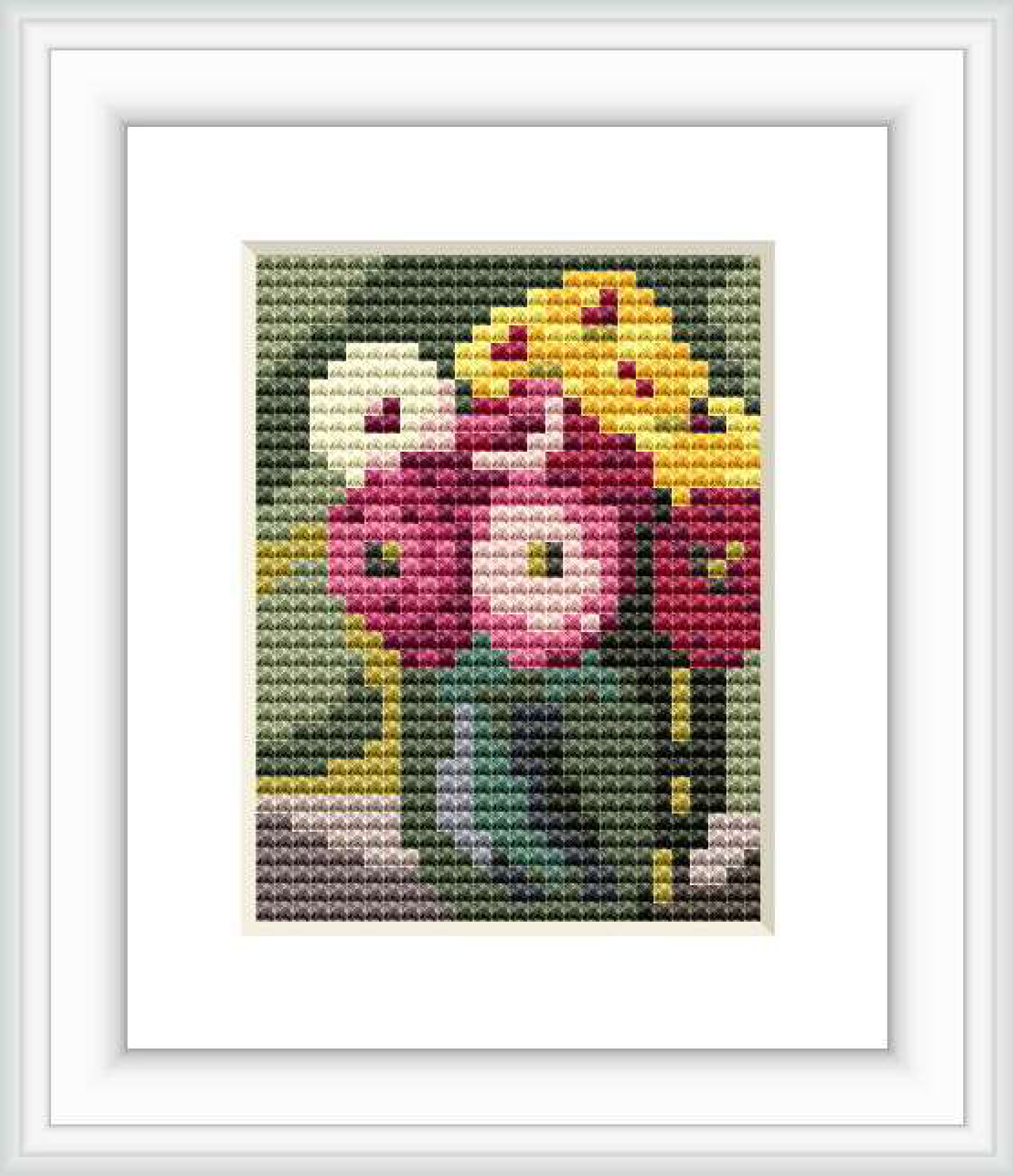The image depicts a cross stitch pattern of vibrant zinnias in various colors placed within a green jar against a dark, olive-colored background.