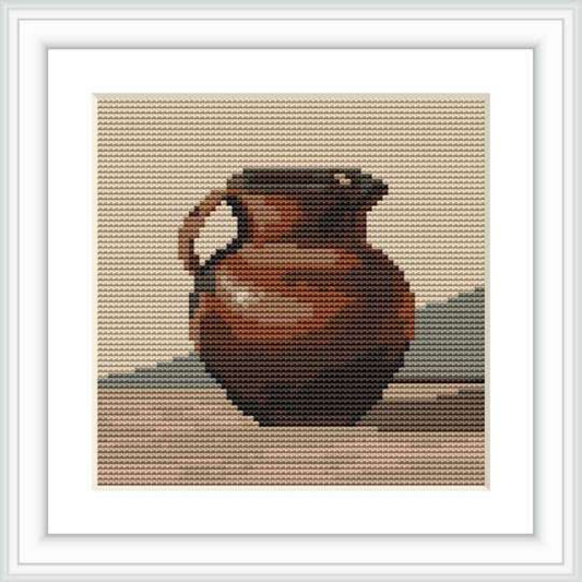 The cross stitch pattern depicts a three-dimensional urn with a rounded belly, narrow neck, and single handle, against a neutral background.