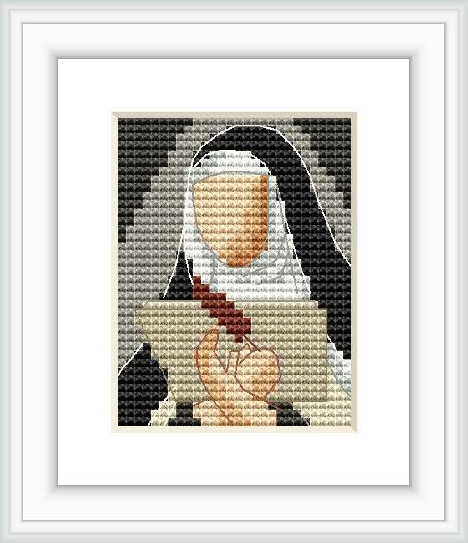 The cross stitch pattern depicts a framed image of St. Teresa of Avila in a habit, with her hands clasped in front of her.