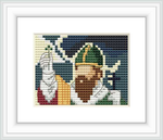 The image displays a framed cross stitch pattern depicting a bearded figure wearing a green hat with a dark green band and a yellow and red outfit.