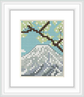 The image presents a cross stitch pattern of Mount Fuji with a blue sky background and lighter blue shading signifying cloud coverage. The forefront features hints of cherry blossom branches in brown with green foliage.