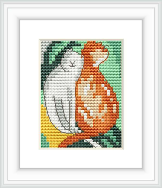 The image depicts two stylized cats, one red and one white, sitting closely together against a background of green and yellow hues. The design is framed within a square border and displayed in a white frame.