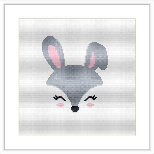 The image displays a cross stitch pattern featuring a stylized cartoon-like rabbit face with prominent ears and a playful expression. The pattern is centered on a evenly stitched canvas, bordered by a simple frame.