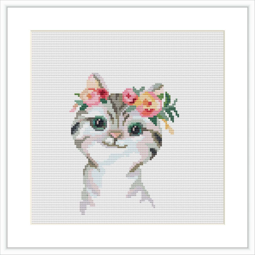 The image shows a cross stitch pattern of a cat's head and upper chest. The cat features a floral crown with pink and yellow flowers and green leaves on its head. The cat has blue eyes and appears to be facing forward.