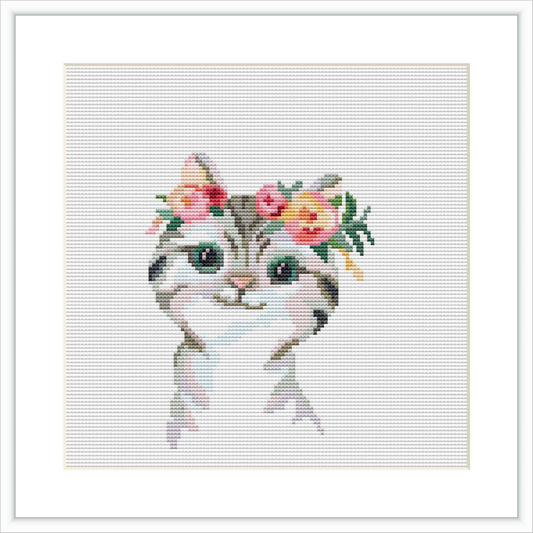 The image shows a cross stitch pattern of a cat's head and upper chest. The cat features a floral crown with pink and yellow flowers and green leaves on its head. The cat has blue eyes and appears to be facing forward.