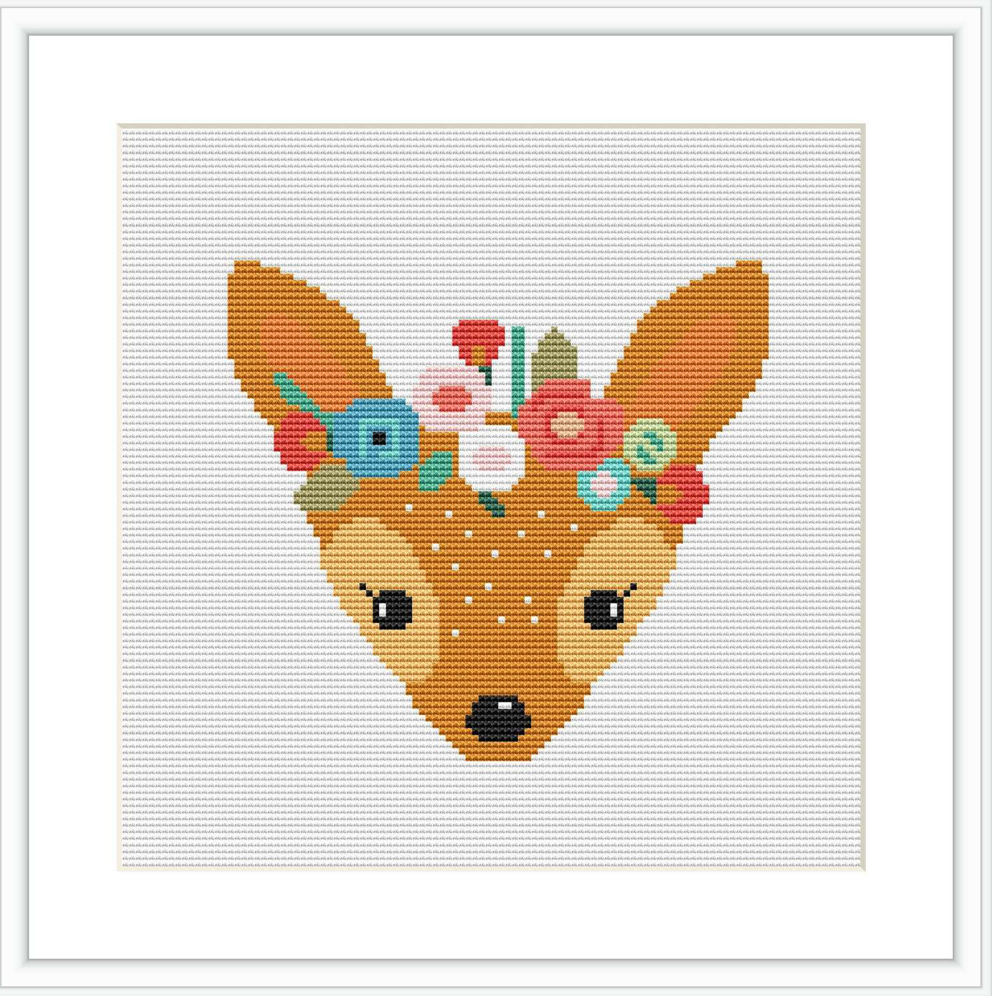 The image depicts a cross stitch pattern of a deer's head with a crown of colorful flowers on its head. The deer is centered against a white background, with a subtle grid visible indicating the pattern's design.