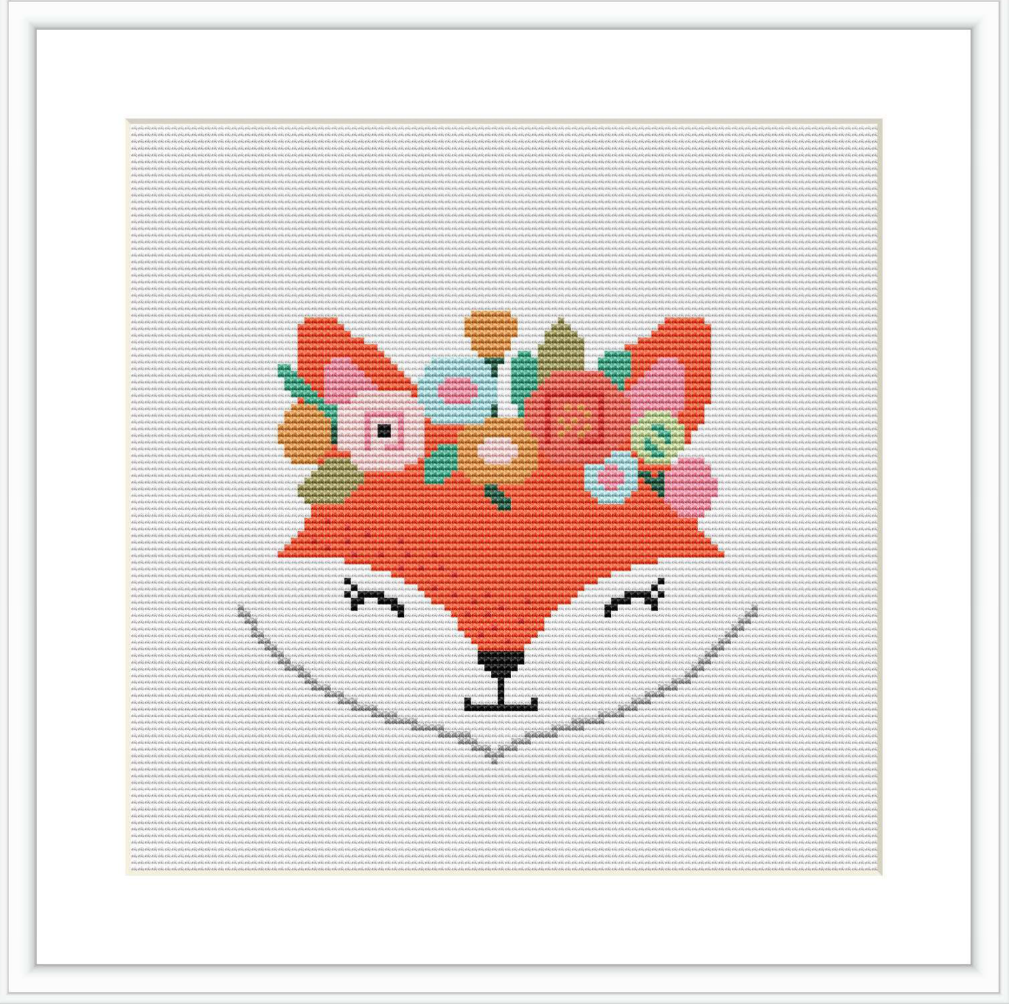 The image shows a cross-stitch pattern of a stylized fox's head with a floral crown. The fox is centered on a white fabric background, framed by a simple black outer border.