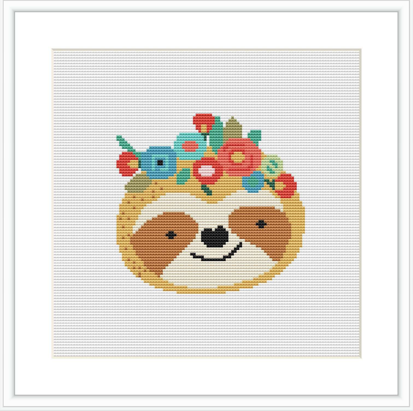 The image showcases a completed cross stitch pattern featuring a cute sloth with a contented expression. The sloth is decorated with a crown of flowers and berries on its head, centered on a white background.