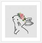 The image shows a cross stitch pattern of a bunny with wings and a floral crown on its head, displayed against a plain white background.