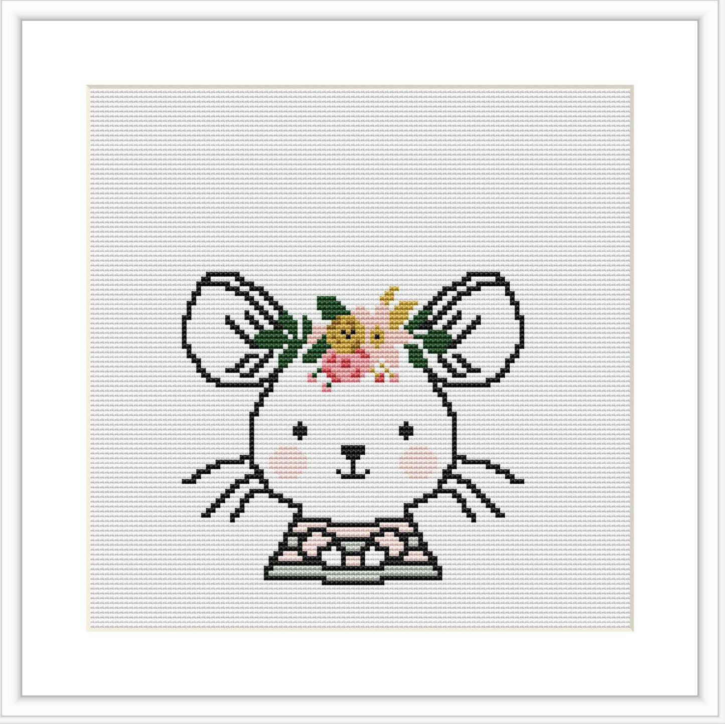 The image displays a cross stitch pattern showing a simplified representation of a mouse facing forward, with ears pointed out to the sides. On its head is a floral crown composed of flowers in pink, yellow, and green. The mouse is stitched in a pale gray, with outlines and features depicted in black and white, and it is centered on a white fabric.