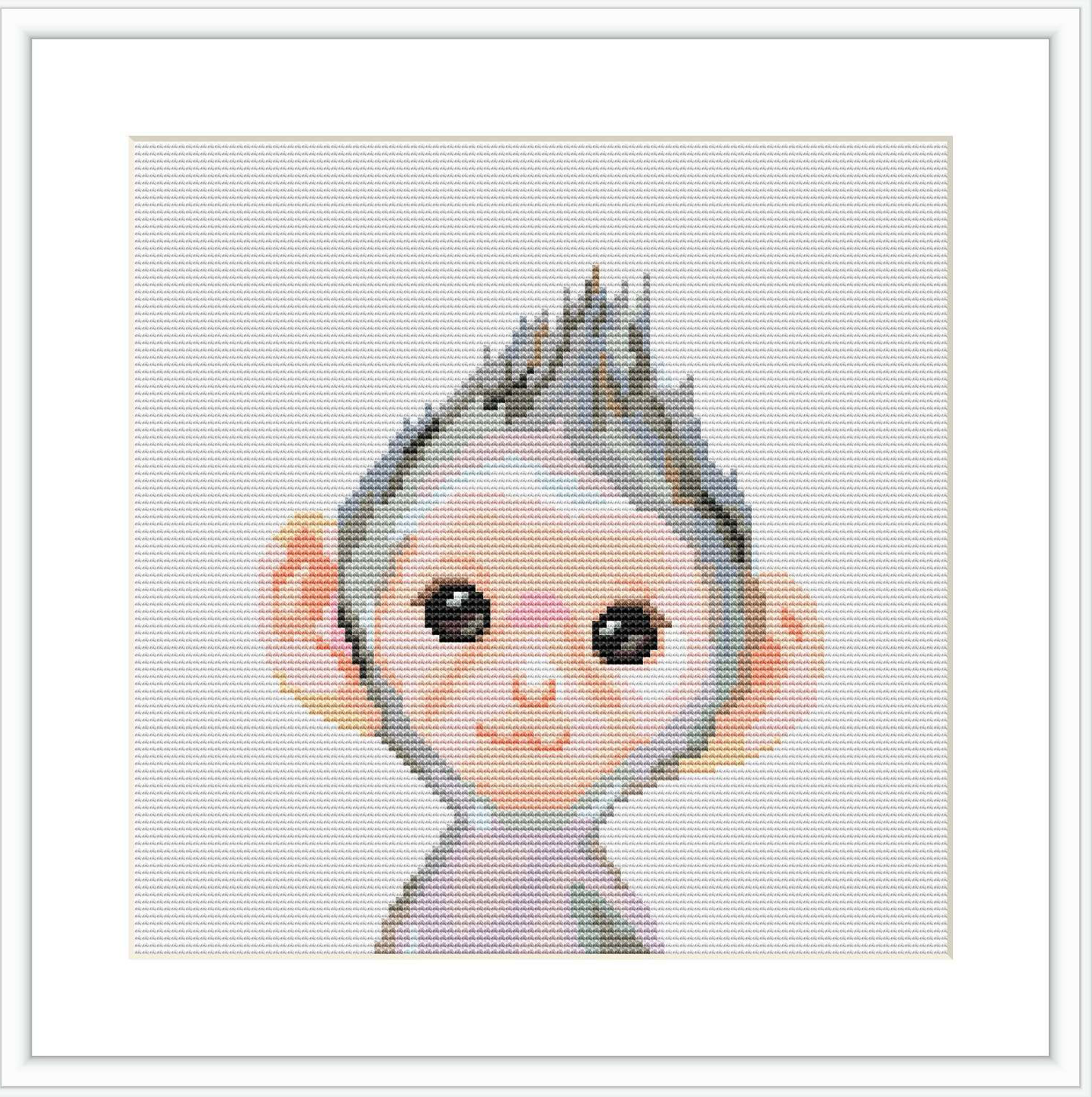 The image showcases a framed cross stitch pattern on a white background. The pattern is a stylized depiction of a baby monkey with oversized ears and an expression of playful innocence.