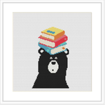 A cross stitch pattern depicting a black bear with a stack of three colorful books on its head. The background is white, and the bear is centered in the frame.