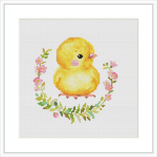 The image displays a cross stitch pattern featuring a cute, plump yellow chick in the center, encircled by a garland of pink flowers and green leaves, all against a white background.