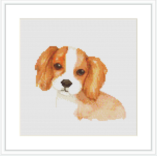 This image shows a framed cross stitch pattern depicting the head and shoulders of a Cocker Spaniel dog against a white background.