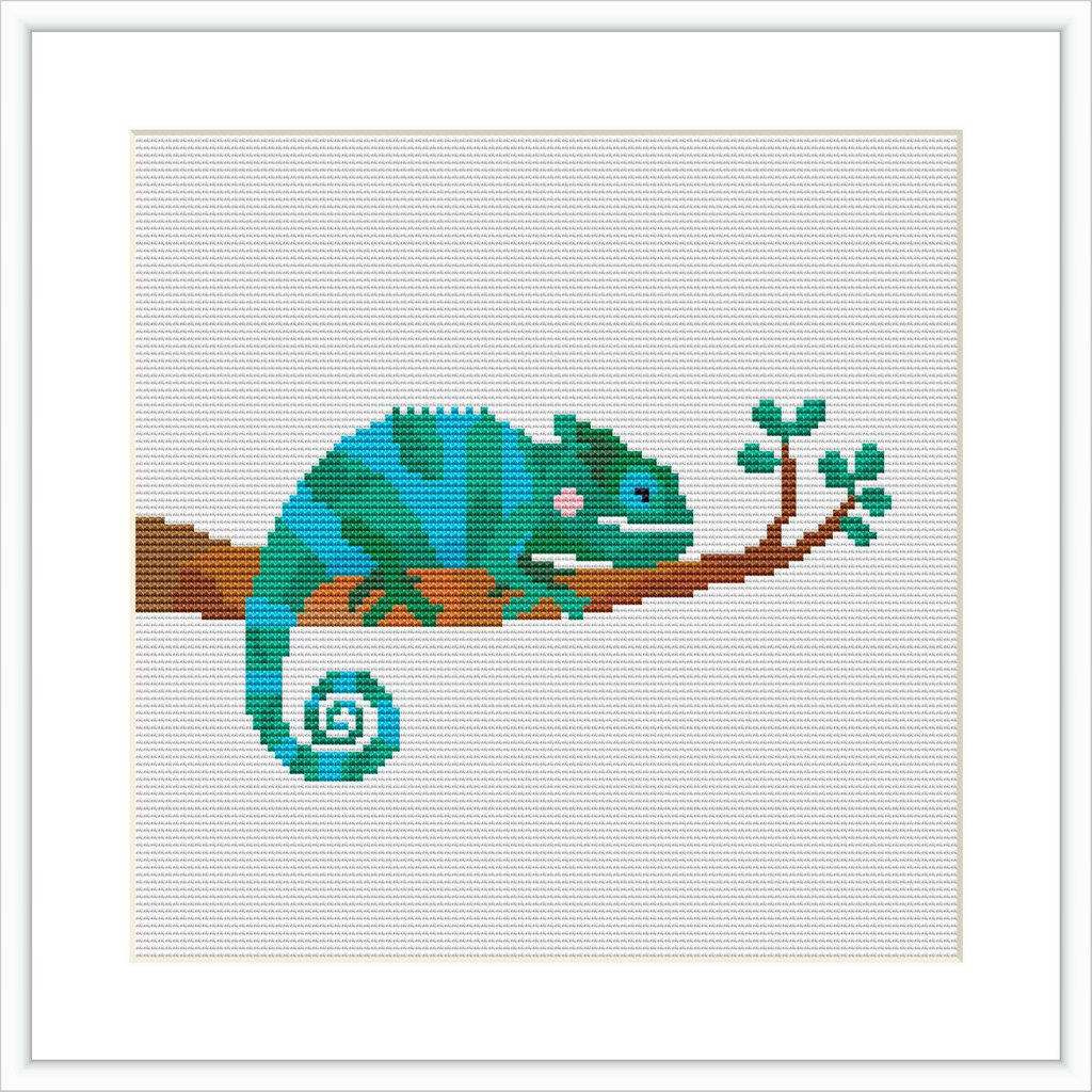 The image features a cross stitch pattern of a turquoise and green chameleon with pink cheeks sitting on a brown branch with green leaves, against a white background.