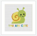 A green snail with a yellow spiral shell, smiling, with the phrase 'YOU ARE CUTE' below it in colorful letters on a white background.